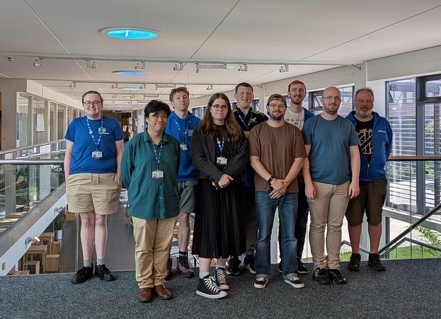 A photo of a group of people standing facing the camera.