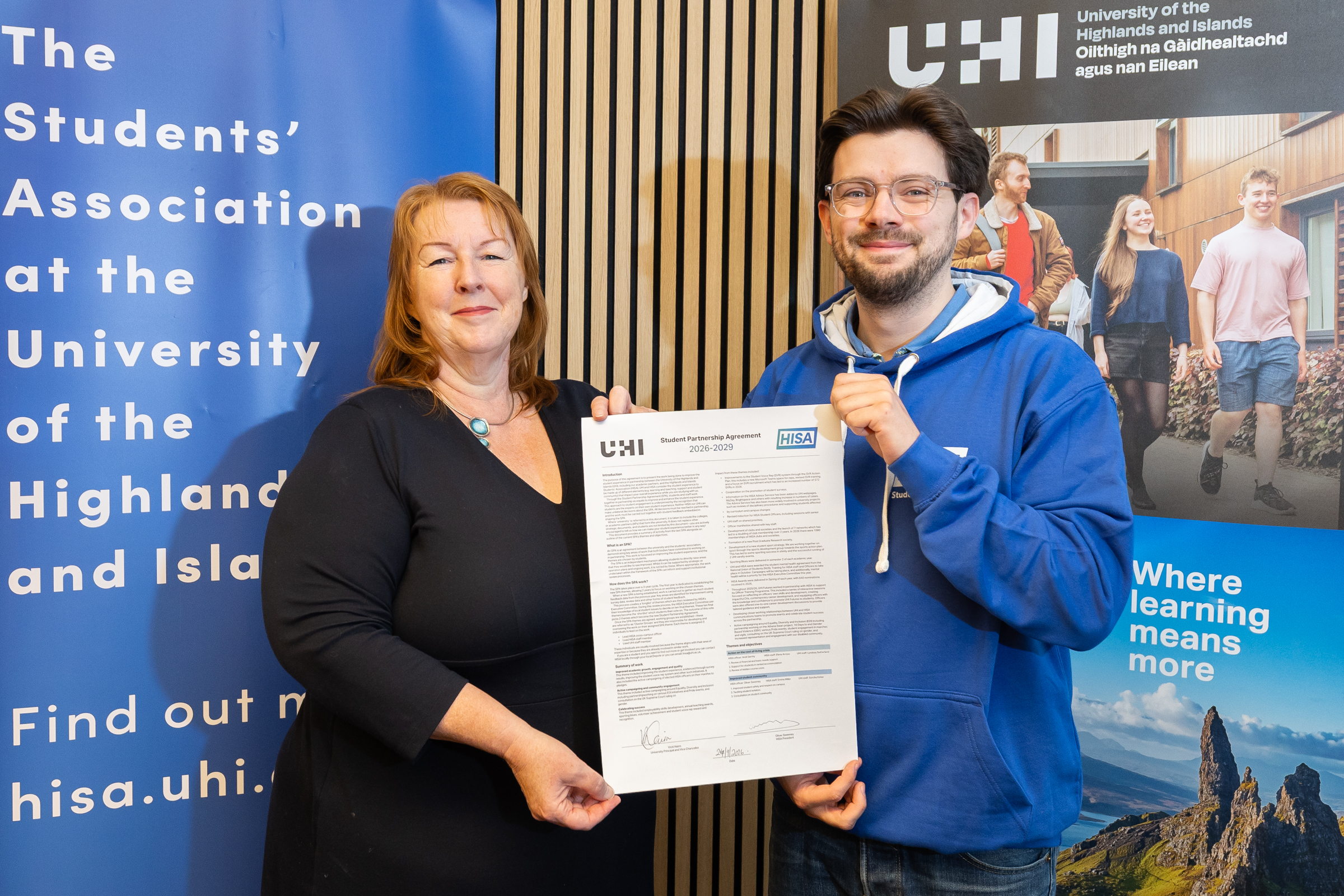 Oliver Sweeney and Vicki Nairn holding the signed document